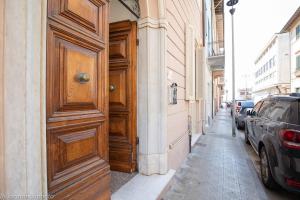 a large wooden door on the side of a building at Gold Apartment Viareggio in Viareggio