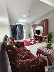 a living room with a couch and a table at Family Villa - BERA Poolstay 