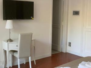 a white desk with a chair and a television on a wall at B&B Madreperla in Gallipoli +50 photos