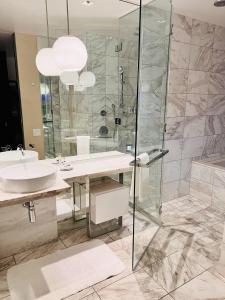 a bathroom with a glass shower and a sink at Luxe Condo Free Parking No Resort Fees in Las Vegas