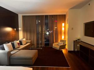 a living room with a couch and a tv at Luxe Condo Free Parking No Resort Fees in Las Vegas