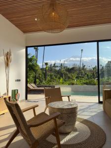 a living room with a table and chairs at Julim Aura - Best Agung View in Amed
