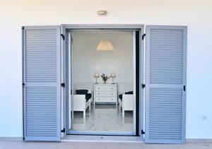an open door leading to a room with a table at Villa Almar in Adamas