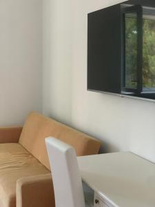 a room with a couch and a table and a window at B&B Madreperla in Gallipoli