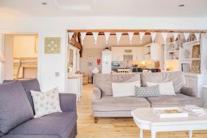 a living room with a couch and a table at The Lodge at Greenbank Farm  +29 photos
