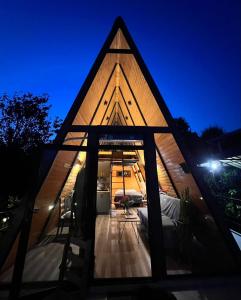 ein dreieckiges Haus wird bei Nacht gezeigt in der Unterkunft Orange Cottage in Agara