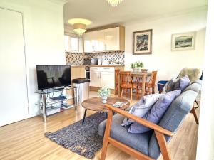 a living room with a couch and a table at 93 Broadside Holiday Chalet near Broads & Beaches in Stalham