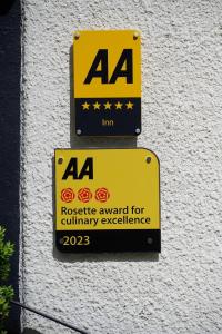 two signs on the side of a building at Bulls Head - Holymoorside in Chesterfield