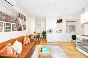 a living room with a couch and a table at Perth City Retreat Victoria Ave 1br in Perth