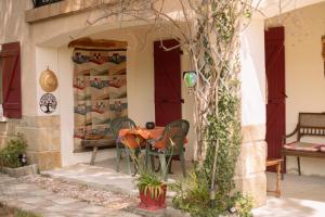 a table and chairs on the porch of a house at Gîte "Chante' Relle" in Privas