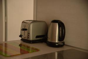 a toaster and coffee maker sitting on a counter at Gîte "Chante' Relle" in Privas