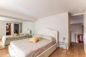 a bedroom with two beds and a large mirror at Gold Apartment Viareggio in Viareggio