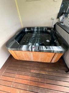 a bath tub sitting on top of a wooden floor at Haven By the Bay- Short walk to Broadwater beach in Broadwater +6 photos