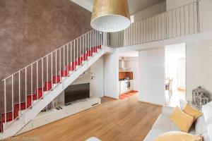 a living room with a staircase and a couch at Gold Apartment Viareggio in Viareggio