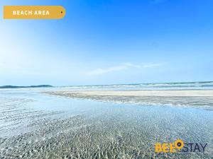 a beach with sand and water on it at Desaru Tiara Beach Resort Pool View 3-5PAX in Bandar Penawar +49 photos