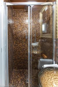 a bathroom with a glass shower with a sink at Gold Apartment Viareggio in Viareggio +26 photos