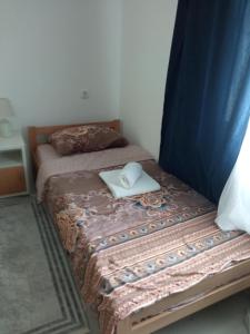 a bedroom with a bed with a laptop on it at Seosko turisticko domacinstvo Milanovic in Žuč +10 photos