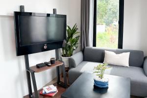 a living room with a tv and a couch at Summer House Fisherman's Village in Bophut 
