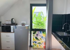 a kitchen with a refrigerator and a window at Summer House Fisherman's Village in Bophut 