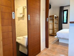 a bathroom with a toilet and a bed in a room at Summer House Fisherman's Village in Bophut 
