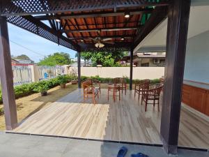 a pergola with chairs and tables on a patio at Homestay Klang in Klang