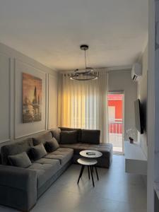 a living room with a couch and a table at DG Apartment in Golem