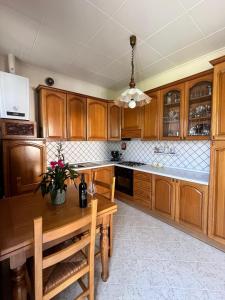 a kitchen with wooden cabinets and a wooden table at La casina di Tata in Terricciola +5 photos