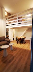 a living room with a couch and tables and a loft at Mairyren Luxury apartment in Ano Syros