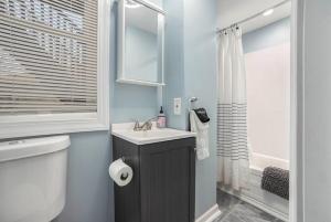 a bathroom with a sink and a toilet at The Downtown Delight - New Corporate Apt Downtown in Grand Rapids