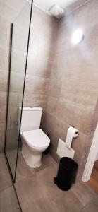 a bathroom with a toilet and a trash can at Mairyren Luxury apartment in Ano Syros
