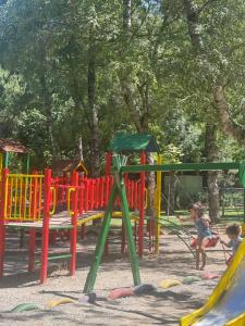 a group of children playing on a playground at NN Villa in Korçë