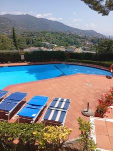 a group of lounge chairs next to a swimming pool at La Casa di Sole by PortofinoVacanze in Rapallo