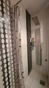 a shower with a shower curtain in a bathroom at Sava Centar in Novi Beograd