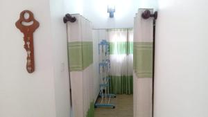 a room with curtains and a key on a wall at Coconut Villa Homestay in Habarana
