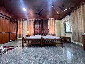 a bedroom with a large bed in a room at Eesha Residency Udupi in Udupi