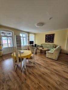 a living room with a table and a couch at Pension Gina in Görlitz
