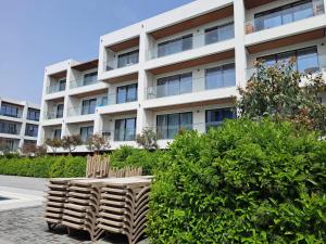 two wooden chairs sitting in front of a building at Sea Breeze in Nardaran