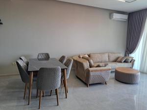 a living room with a table and a couch at Sea Breeze in Nardaran