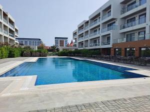a swimming pool in front of a building at Sea Breeze in Nardaran