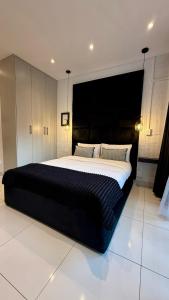 Ένα ή περισσότερα κρεβάτια σε δωμάτιο στο The Monochrome Apartment 209 - Urban Chic Escape - Open Plan Bathroom with Bathtub