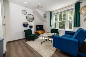 a living room with blue chairs and a table at Modern 2-Bed Apartment - Near Train and Town - Parking Available in High Wycombe