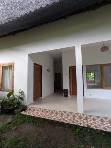 an empty room of a house with a porch at ADA Rooms in Kuta Lombok +19 photos