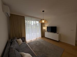 a living room with a couch and a flat screen tv at Teresin Nest in Teresin