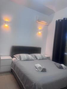 a bedroom with a bed with two towels on it at Maria House in Artemida