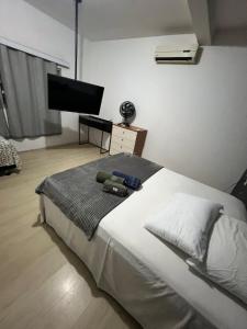 En eller flere senge i et værelse på Jardim Camburi Reserve