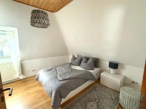 a bedroom with a bed and a couch in it at Gemütliche Ferienwohnung in Ennepetal