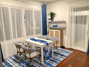 a dining room with a table and four chairs at Love at First Sight in Chumphon