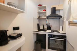 a small kitchen with a stove and a sink at Arokaria Studios by PaxosRetreats in Gaios +20 photos