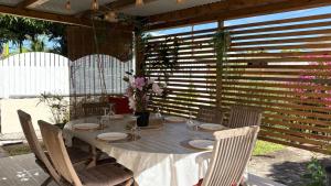 a table with plates and flowers on a patio at Fleurs de mangue in Saint-Louis