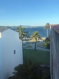 a view of the ocean and palm trees from a building at Casa Parlera in Ribeira